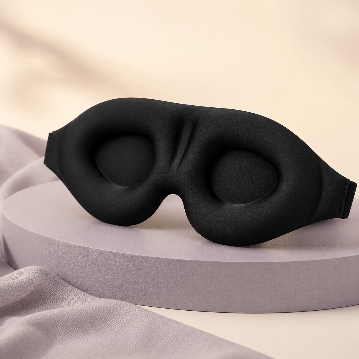 DayHush 3D Blackout Sleep Mask on a warm cream and lavender studio set
